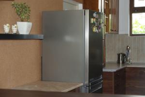a kitchen with a stainless steel refrigerator in a kitchen at Guesthouse Viktoria in Peshtera