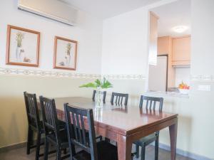 a dining room with a wooden table and chairs at Marineu Las Arenas in Alcossebre