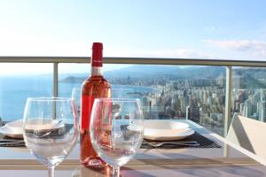 a bottle of wine sitting on a table with wine glasses at Skyscraper apartment with panoramic views - floor 38 in Benidorm