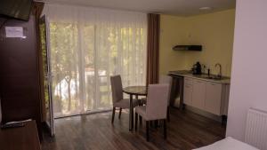 a kitchen with a table and chairs in a room at Casa Horea in Deva