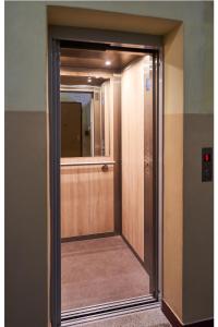 a wooden door with a mirror in a room at Kwiatowa Warsaw Apartment in Warsaw