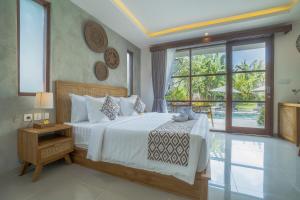 a bedroom with a bed and a large window at Ranggen Ubud in Ubud +44 photos