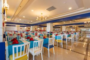 a banquet hall with blue and white tables and chairs at Orange County Belek in Belek