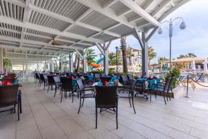 a restaurant with tables and chairs on a patio at Orange County Belek in Belek