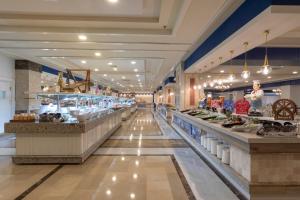 a long aisle of a grocery store with food at Orange County Belek in Belek