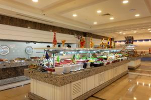 a buffet line with bowls of food in a restaurant at Orange County Belek in Belek