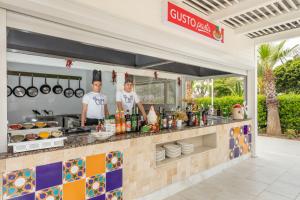 two men standing in front of a food cart at Orange County Belek in Belek