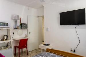a living room with a flat screen tv on a wall at MyKhaya-your home away from home in Kempton Park