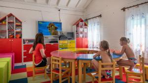 a group of children sitting at a table in a play room at Orange County Belek in Belek +37 photos