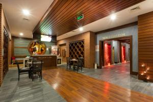 a wine tasting room with chairs and a bar at Orange County Belek in Belek