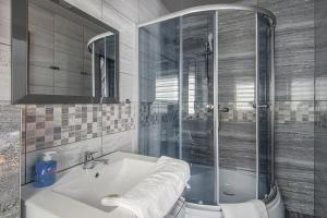 a bathroom with a shower and a sink at Apartamenty Majerczyk in Zakopane +78 photos