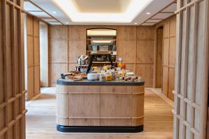 a restaurant with a counter with food on it at Hotel Les Haras in Strasbourg +45 photos