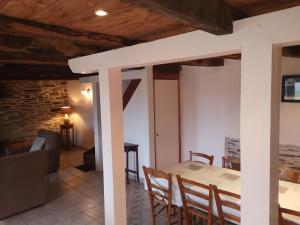 a kitchen and dining room with a table and chairs at Nid douillet en Foret de Broceliande in Ploërmel