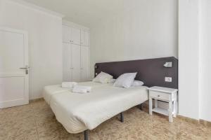 sypialnia z dużym łóżkiem i szafką nocną w obiekcie Apartamento Albatros w mieście Playa de San Juan