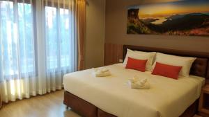 Postel nebo postele na pokoji v ubytování Ben Guesthouse