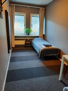 a bedroom with a bed and a window at Vandrarhem Uppsala - Portalgatan in Uppsala