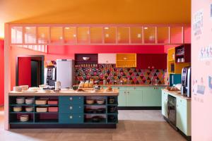 a kitchen with colorful cabinets and a counter top at PAUL & PIA - Welcome Home Hotel in Colmar