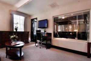 a hotel room with a desk and a large window at The Montcalm At Brewery London City in London