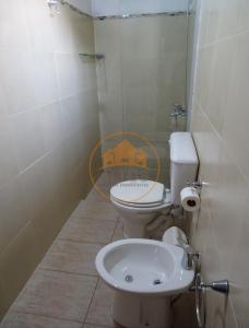 a bathroom with a toilet and a sink at La Blanquita in Potrero de Garay