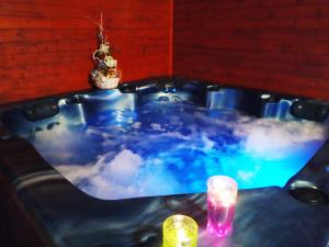 a jacuzzi tub with clouds in it with two candles at Pension Bílý Hořec in Vrchlabí