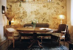 a dining room with a wooden table and chairs at Shila Athens in Athens