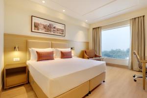 Lemon Tree Hotel, Jhansi客房内的一张或多张床位