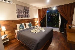 a hotel room with a bed and a window at PNB Beach Resort in Canggu