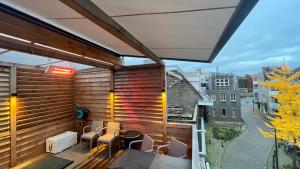 a balcony with a table and chairs and a view at Stylish house in the heart of Breda city center in Breda