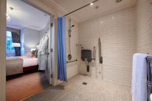 a bathroom with a bed and a shower at The Bonham in Edinburgh