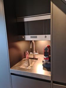 a kitchen with a sink and a counter top at Canal view suite in Amsterdam