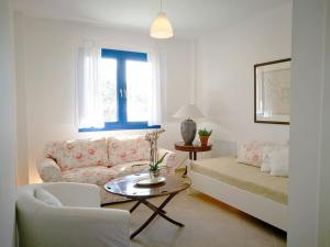 a living room with a couch and a table at Olive Bay Hilltop Apartments Ammouliani in Ammouliani