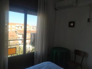 1 dormitorio con cama y ventana con vistas en Hostal agripino y Restaurante asiático, en Mora