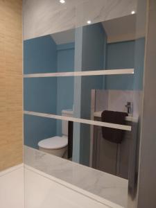 a bathroom with a toilet and a glass wall at Watercress Barns in Sittingbourne