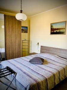 a bedroom with a large bed with a blue blanket at Agriturismo Cascina Mariale in Albiano dʼIvrea