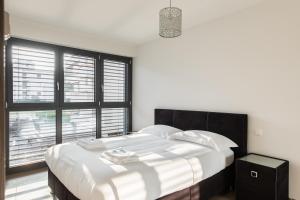 a bedroom with a large bed with a large window at Lucy by Quokka 360 - a stone's throw from the station in Massagno