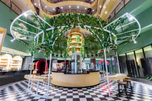 a restaurant with trees and plants on the ceiling at Dusit Thani Dubai in Dubai