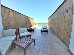 a balcony with couches and chairs on a building at Belussi Exclusive Suites in Kipseli