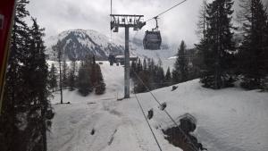 a ski lift with a snow covered mountain in the background at Hôtel et Appart'Hôtel Restaurant L'Adray in Longefoy