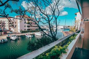 uma vista para um porto com barcos na água em Superbe T2 au calme avec balcon sur la marina - 10 em Canet-en-Roussillon