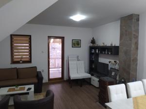 a living room with a couch and a tv at Vila Žubor in Crni Vrh