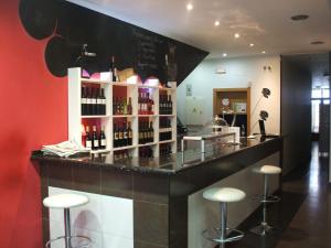 a bar with a bunch of bottles of wine at Hostal Catalina de Austria in Torquemada