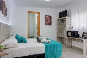 a bedroom with a large bed with a blue table at Villa Mamba By Seric,15' walking to the beach in Torremolinos +23 photos
