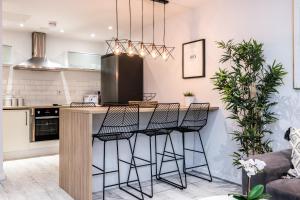 a kitchen with a island with bar stools at Host & Stay - Baltic Balcony Apt in Liverpool