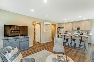 a living room with a couch and a kitchen at Liberty Bay Loft & Front Street Suite in Poulsbo