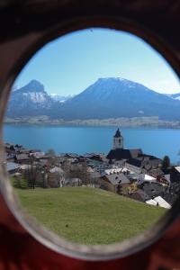 a view of a town with a lake and mountains at Hotel Zimmerbräu in St. Wolfgang