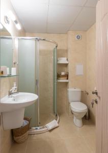 a bathroom with a shower and a toilet and a sink at Aquamarine in Pomorie +21 photos