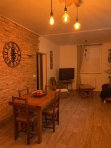 a living room with a table and chairs and a television at gîte de nonna in Givet