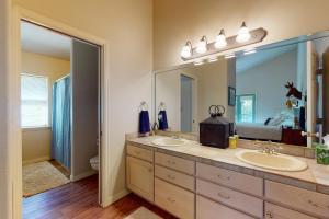 a bathroom with two sinks and a large mirror at Two Rivers Retreat in South Fork +84 photos