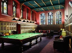 a room with a pool table and stained glass windows at Raven Wing 2 Apartment- Highland Club Scotland in Fort Augustus