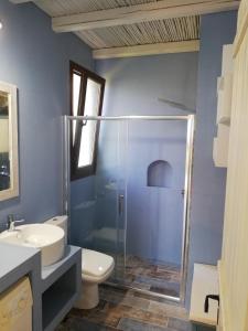 a bathroom with a shower and a toilet and a sink at Anio Residence - Rustic Modern with Sea and Mountain View Terrace in Svoronata